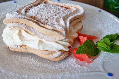 a white plate with a piece of cake and strawberries at S'Hort de Son Caulelles - Adults Only in Marratxí 