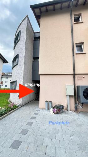 a building next to a building with a building at Modern appartment self-check-in in Stans