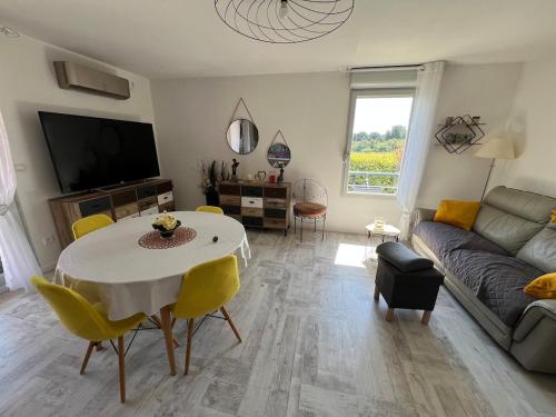 un salon avec une table et un canapé dans l'établissement Appartement vue château, à Carcassonne