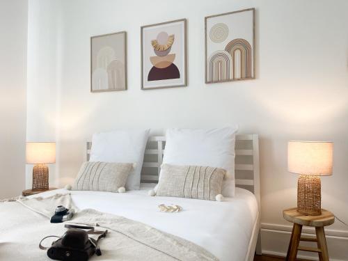 a bedroom with two beds and three pictures on the wall at Le Refuge, Pet friendly, Free Parking in Pagny-sur-Moselle