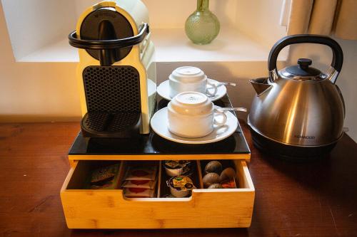 a wooden box filled with food and a tea kettle at S'Hort de Son Caulelles - Adults Only in Marratxí 
