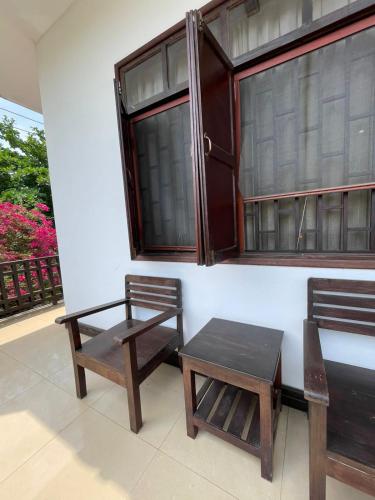 two chairs and a table next to a window at Luang Prabang Inn 1 in Luang Prabang
