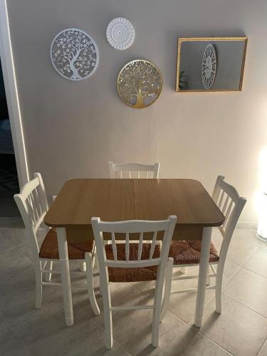 a dining room table with chairs and plates on the wall at Casa Moly in Monopoli