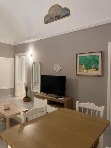 a living room with a table and a television at Casa Moly in Monopoli