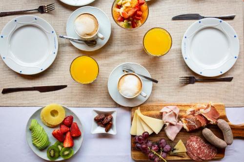 a table with plates of food and cups of coffee at S'Hort de Son Caulelles - Adults Only in Marratxí 