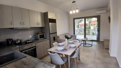 a kitchen with a table and chairs in a kitchen at EVDOKIAS Apt,brand new 2025 modern Apt in the center of Alikanas in Alikanas