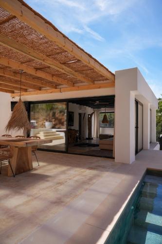 an outdoor patio with a table and a swimming pool at Villa Romeo in Sant Jordi