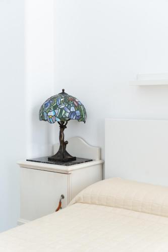 a bed room with two beds and a lamp at Villa Alba - Zaffiro in Amalfi