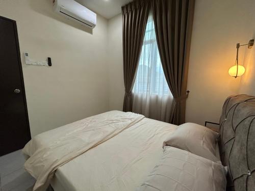 a bedroom with a white bed and a window at iHomie Suites - Homestay Kulim in Kulim