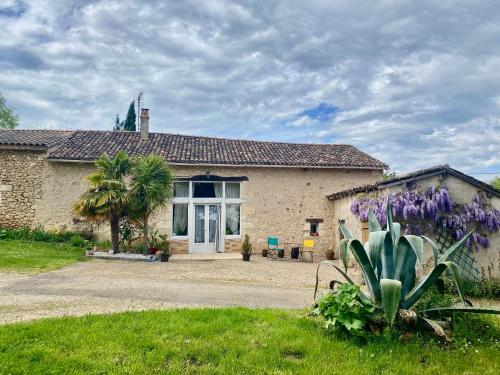 a house with a cactus in front of it at GITE LE PARC in Villamblard