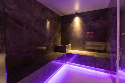 a bathroom with a tub with purple lighting at Hotel Europa in Sirmione