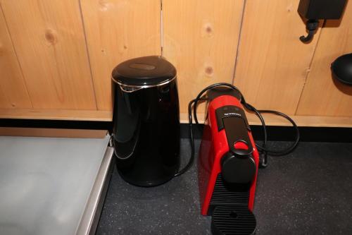 a black and red appliance sitting next to a counter at Glamping De Zuidvliet Nr 12 in Wolphaartsdijk