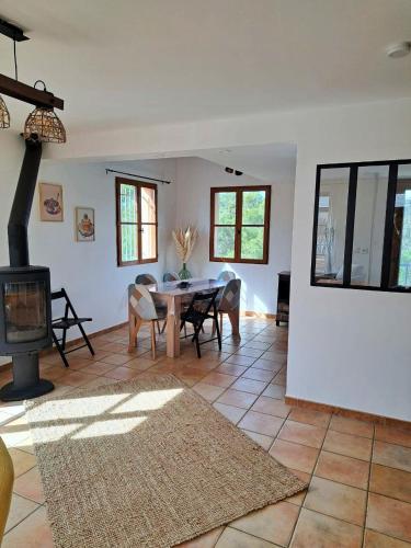 un salon avec une table et une cheminée dans l'établissement Villa Haut de Gamme Golf de Pont Royal 6 Personnes, Climatisé, Piscine, à Mallemort