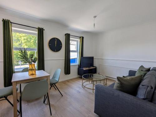 a living room with a couch and a table at Saffron Court Apartments - Apt 14 in High Wycombe