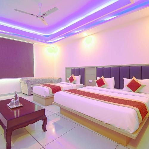 a hotel room with two beds and a couch at LE - CASHEW By 2 Minute Walking New Delhi Railway Station - Metro Station Main Road Building in New Delhi