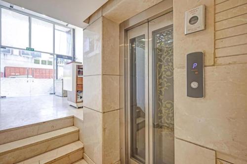 a elevator in a building with a sign on the wall at LE - CASHEW By 2 Minute Walking New Delhi Railway Station - Metro Station Main Road Building in New Delhi
