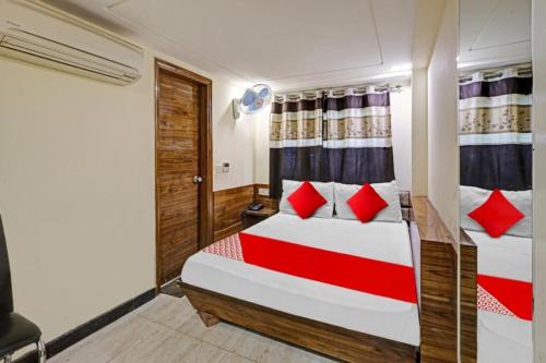 a bedroom with a bed with red pillows at LE - CASHEW By 2 Minute Walking New Delhi Railway Station - Metro Station Main Road Building in New Delhi