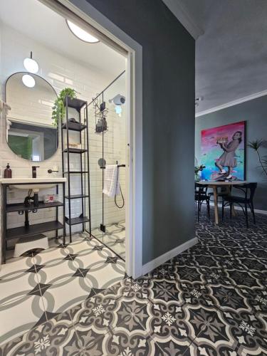 a bathroom with a mirror and a sink and a table at APTER-Boutique Apartment אפטר - דירת בוטיק בכנרת in Tiberias