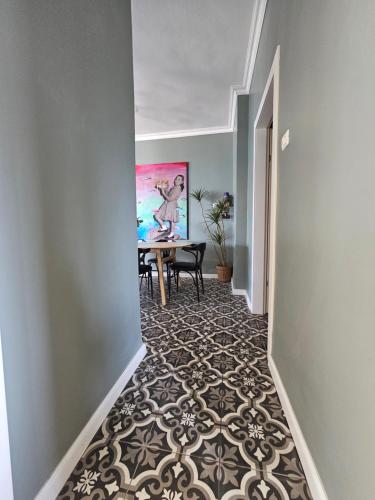 a hallway with a table and a dining room at APTER-Boutique Apartment אפטר - דירת בוטיק בכנרת in Tiberias