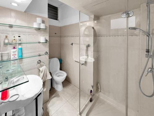 a bathroom with a shower and a toilet and a sink at Elegant Beachside Apartment in Herzliyya B