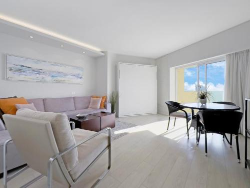 a living room with a couch and a table at The Sharon Sky Suite in Herzliya B