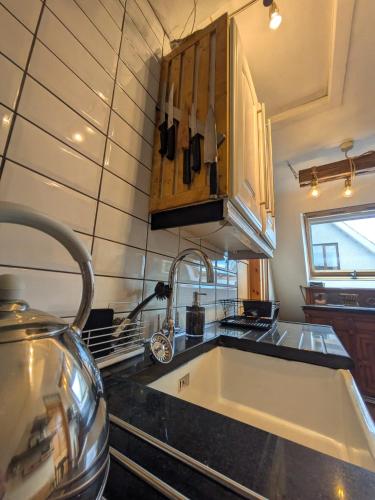 a kitchen with a sink and a counter top at The Loft at Rowantree Cottage in Dromara