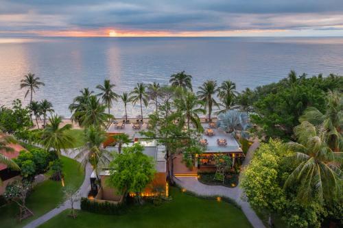 an aerial view of a resort with palm trees and the ocean at Anantara Hua Hin Resort in Hua Hin