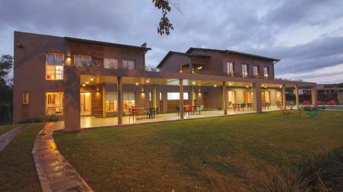 a large house with a lawn in front of it at Amalinas Hotel in San Lorenzo