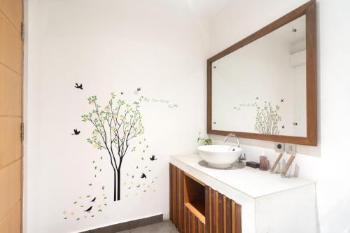 a bathroom with a sink and a mirror at Gili Khayangan Villas in Gili Trawangan