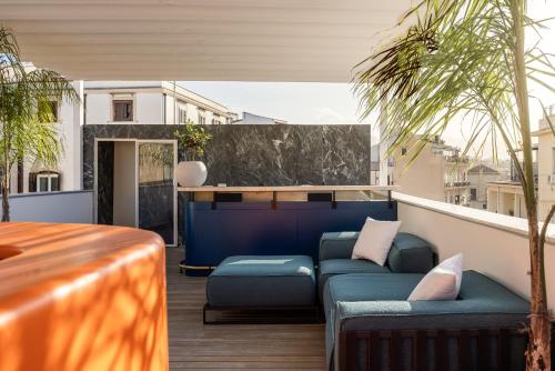 a balcony with a couch and chairs on a roof at LOCANDA SANTAMARINA Dimora di Charme in Palermo