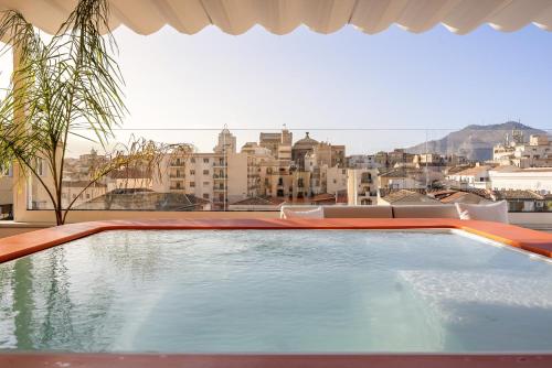 a swimming pool with a view of a city at LOCANDA SANTAMARINA Dimora di Charme in Palermo