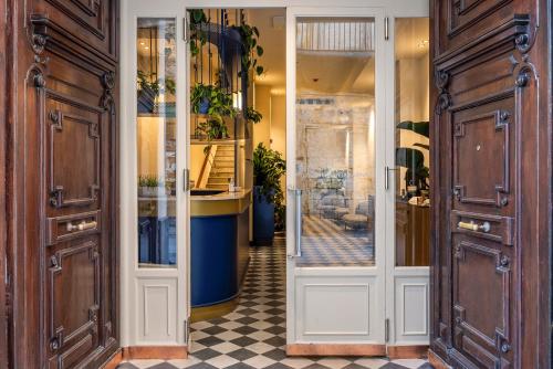 a hallway with doors and a checkered floor at LOCANDA SANTAMARINA Dimora di Charme in Palermo