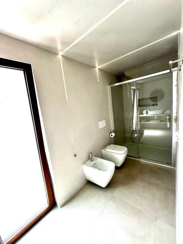 a bathroom with a sink and a toilet in it at Villa Mameli b&b in Rena Majore