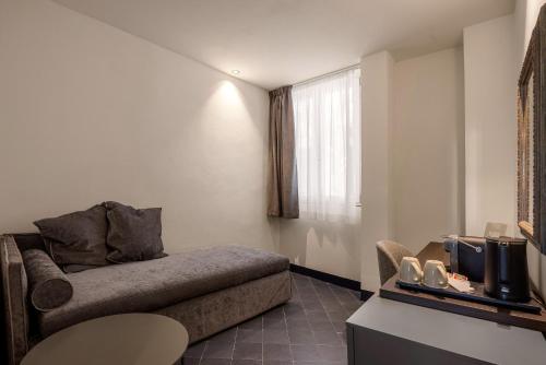 a living room with a couch and a window at LOCANDA SANTAMARINA Dimora di Charme in Palermo