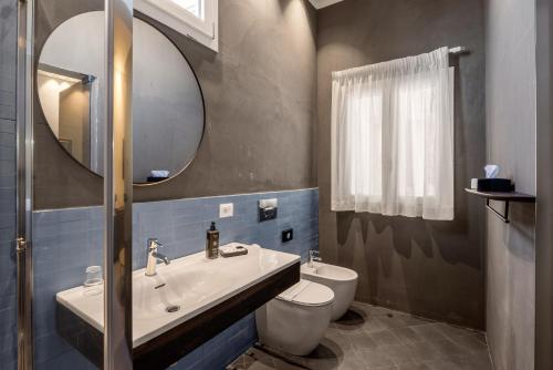 a bathroom with a sink and a toilet and a mirror at LOCANDA SANTAMARINA Dimora di Charme in Palermo