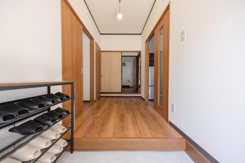a hallway of a house with wood floors and a staircase at Shima Yadori in Oshima
