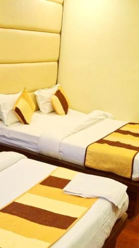 two beds sitting next to each other in a room at Hotel Atlantic Paradise in Ajmer