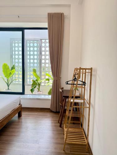 a room with a desk and a ladder and a window at Hi Homestay - Near Kitesurfing My Hoa in Phan Rang