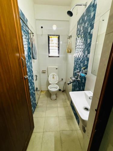 a small bathroom with a toilet and a sink at Panama & Panama Hotel and Restaurant in New Town