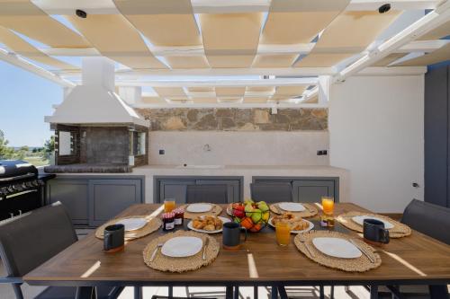 a wooden table with food on it in a kitchen at Villa Vasaltis & Selestitis in Gennadi