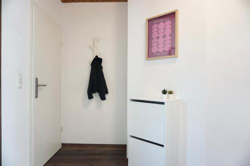 a white room with a refrigerator and a door at NEU zentrale Wohnung Netflix Balkon 4 Gäste in Andernach