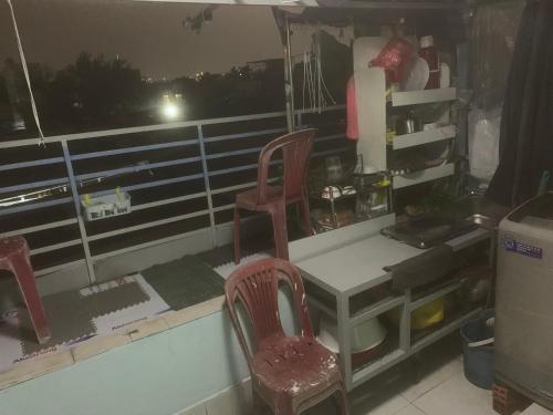 a kitchen with two chairs and a desk and a window at Room4 Double-Bed Private Bath in Ho Chi Minh City