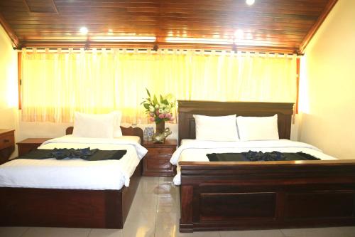Ένα ή περισσότερα κρεβάτια σε δωμάτιο στο Shining Angkor Apartment Hotel