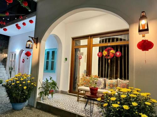 a entrance to a building with flowers in front at VYA homestay Huế in Thôn Lại Thê