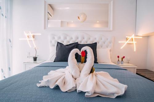 two swans made out of towels on a bed at Valtos View in Parga