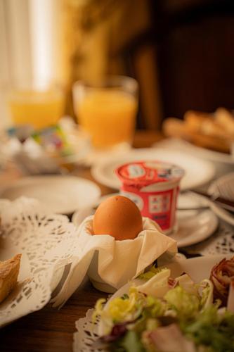 an egg in a wrapper on a table with food at Hotel Miami in Rome