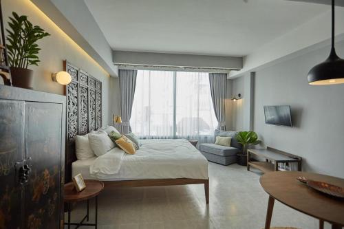 a bedroom with a bed and a living room at Stylish Studio in Prime Sukhumvit-Next to BTS Nana in Bangkok