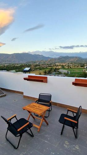 two chairs and a table on top of a roof at Hi Homestay - Near Kitesurfing My Hoa in Phan Rang