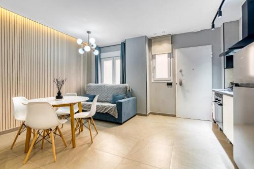 a kitchen and dining room with a table and chairs at City Suites in Valencia