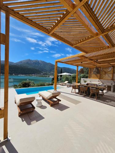 an outdoor patio with a view of the water and mountains at Villa Aenya in Yenion
